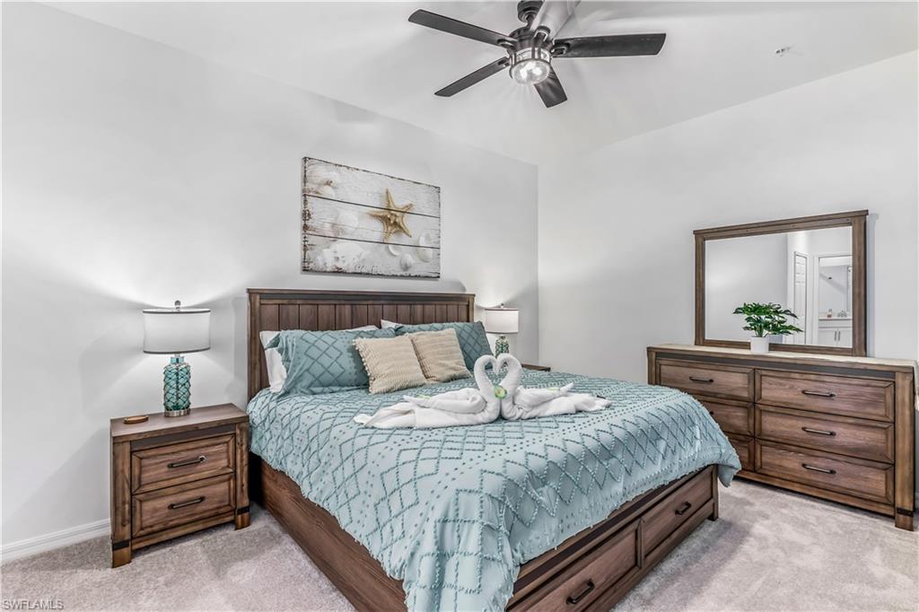 43989 Boardwalk Loop, Unit 2046 Babcock Ranch, FL 33982 - Photo 11 of 12 a bedroom with a bed and ceiling fan
