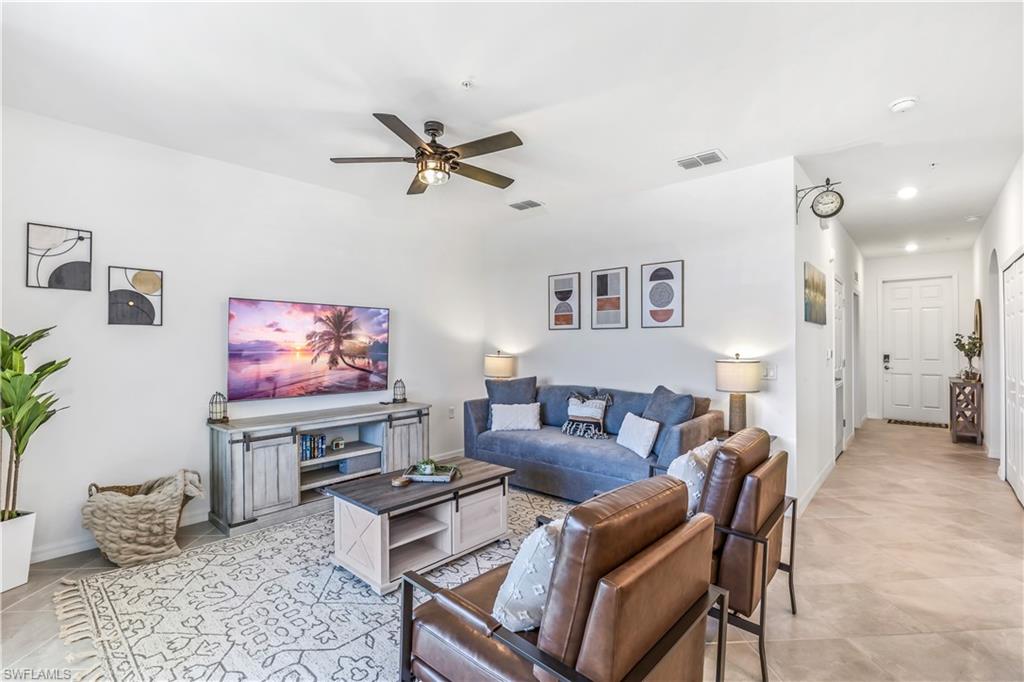 43989 Boardwalk Loop, Unit 2046 Babcock Ranch, FL 33982 - Photo 5 of 12 a living room with furniture and a flat screen tv