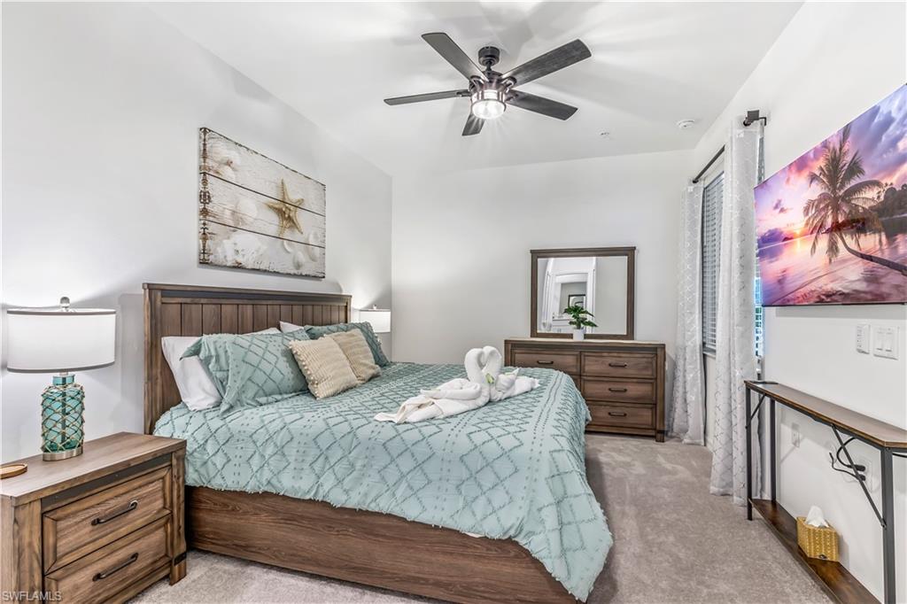 43989 Boardwalk Loop, Unit 2046 Babcock Ranch, FL 33982 - Photo 10 of 12 a bedroom with a bed and a lamp on dresser