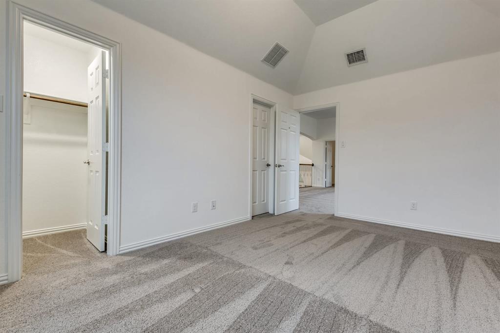 104 Sweetleaf Drive Red Oak, TX 75154 - Photo 24 of 36 This room features vaulted ceilings, light grey carpet, and white walls
