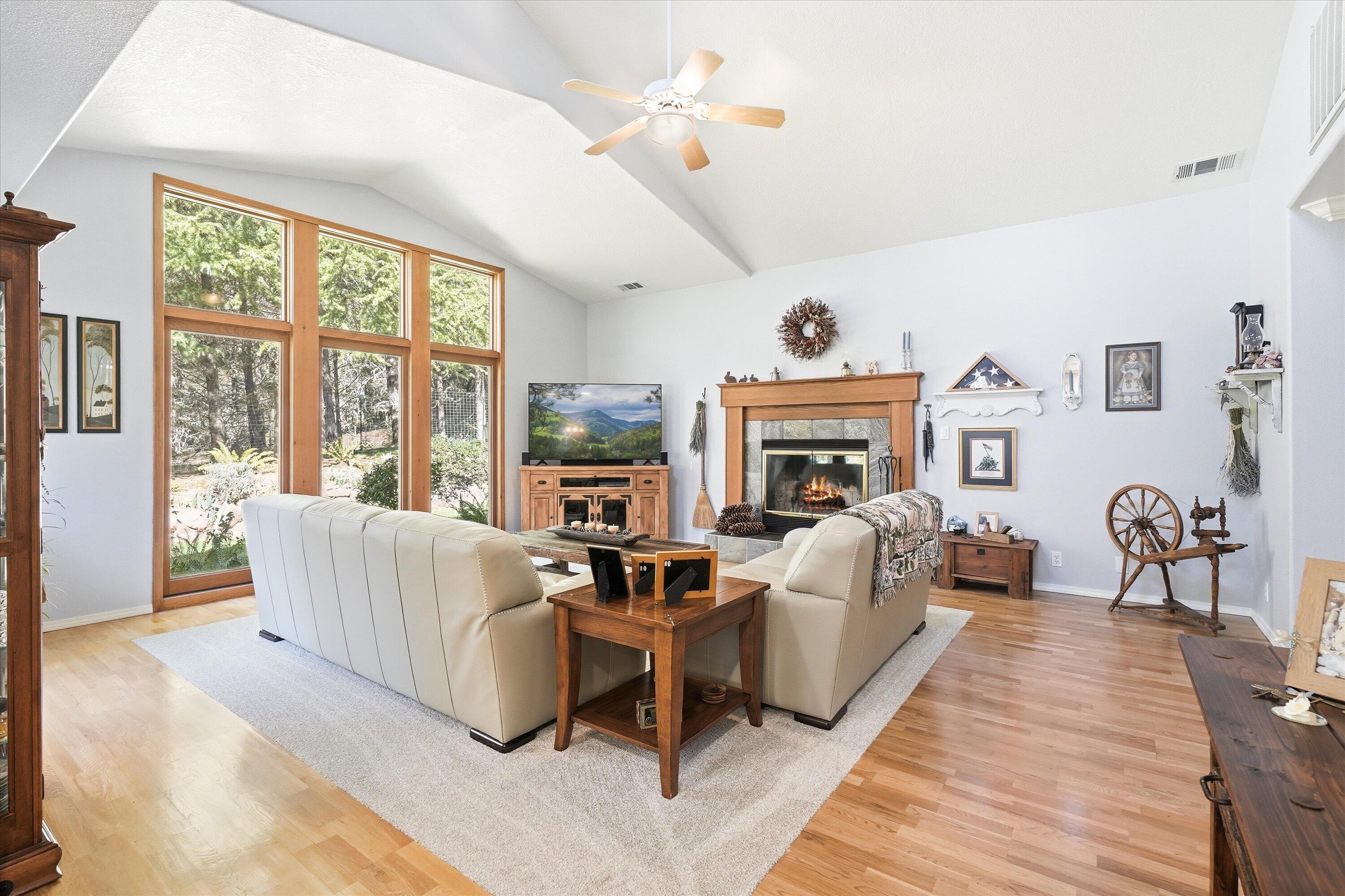 916 Ferry Road Grants Pass, OR 97526 - Photo 8 of 64 Light and bright living room with a wood burning fireplace.