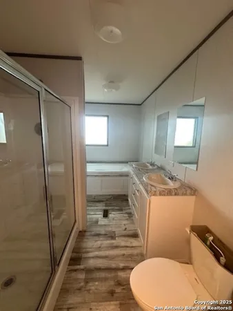 a bathroom with a sink toilet and shower