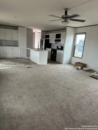a view of a kitchen with a sink and a window