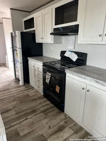 a kitchen with stainless steel appliances granite countertop a stove a refrigerator and a microwave