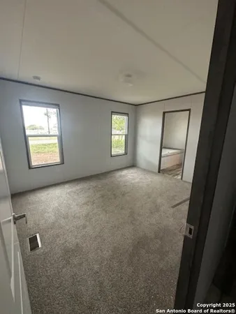 an empty room with windows and closet