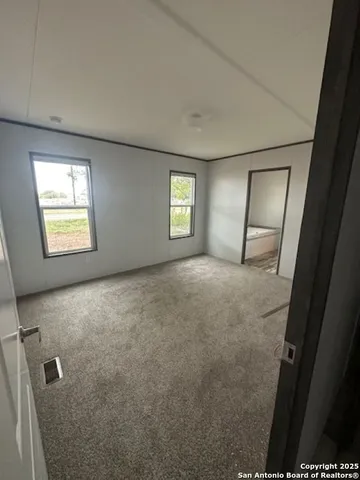 an empty room with windows and closet