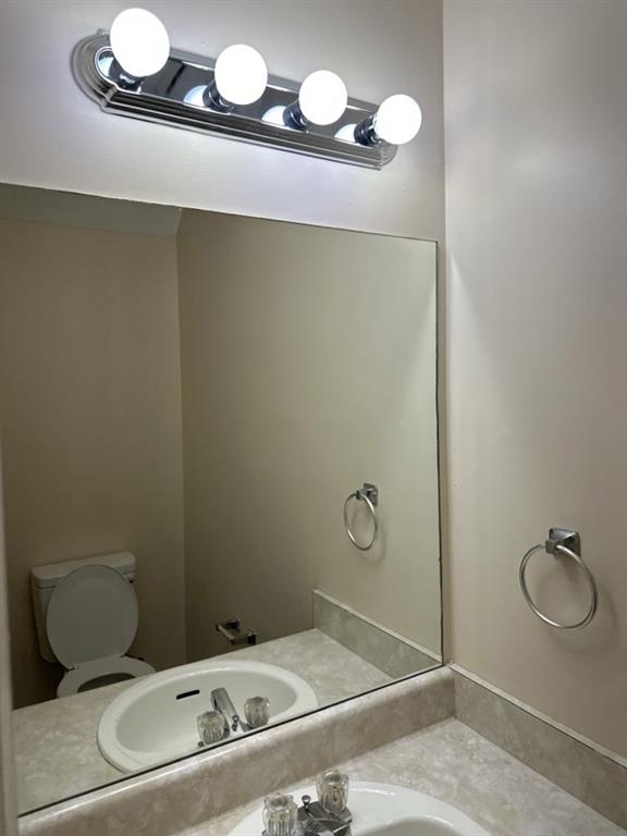 5956 North Castlegate Drive Atlanta, GA 30349 - Photo 16 of 28 a bathroom with a sink and mirror
