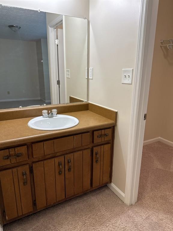 5956 North Castlegate Drive Atlanta, GA 30349 - Photo 19 of 28 a bathroom with a sink and a mirror