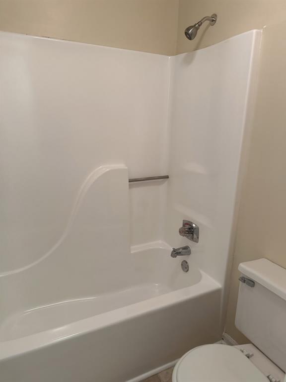 5956 North Castlegate Drive Atlanta, GA 30349 - Photo 24 of 28 a bathroom with a bathtub and a toilet