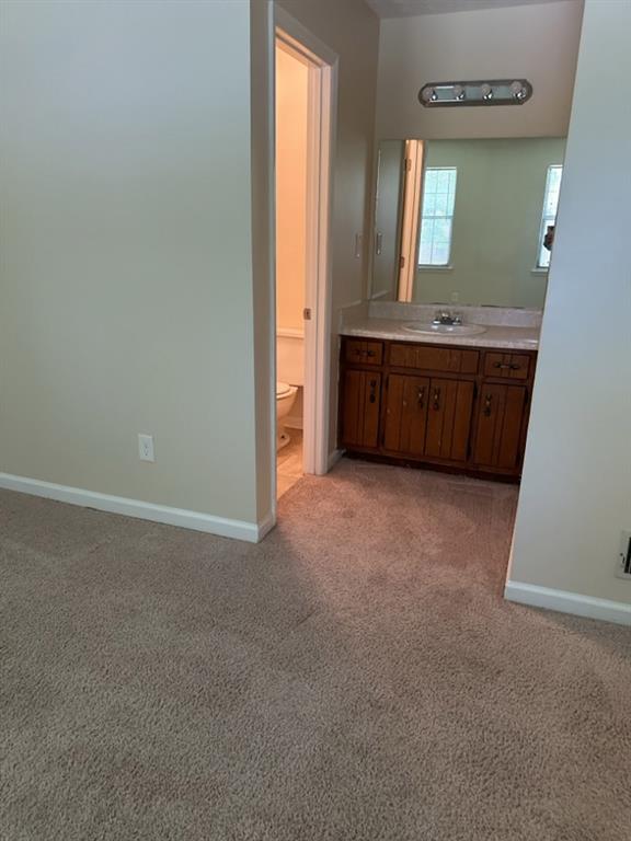 5956 North Castlegate Drive Atlanta, GA 30349 - Photo 26 of 28 a bathroom with a sink and a mirror