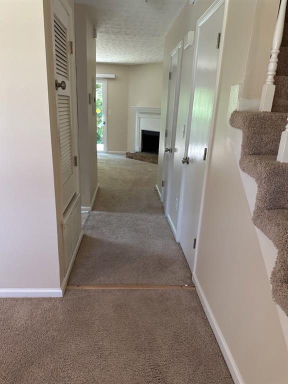 5956 North Castlegate Drive Atlanta, GA 30349 - Photo 3 of 28 view of a hallway with wooden floor and a fireplace