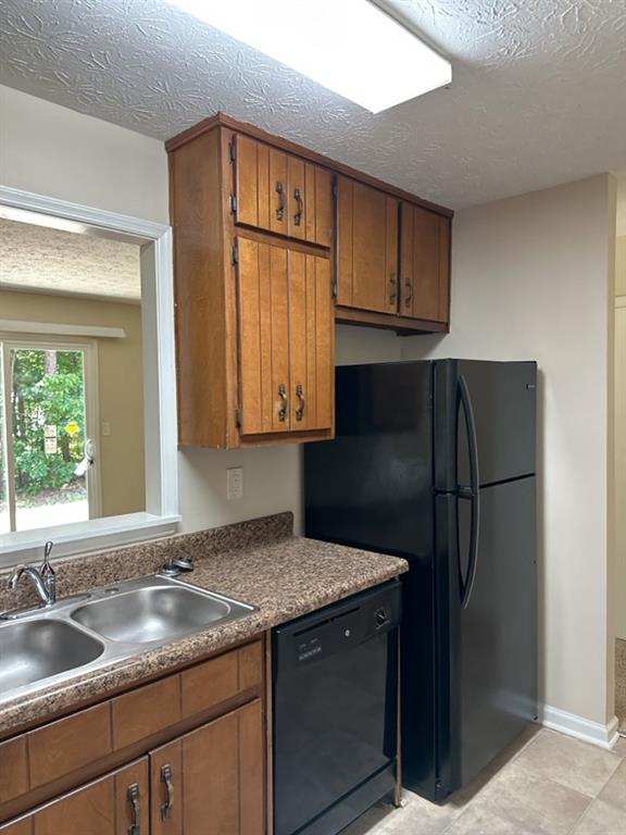 5956 North Castlegate Drive Atlanta, GA 30349 - Photo 8 of 28 a kitchen with granite countertop stainless steel appliances a refrigerator and a sink