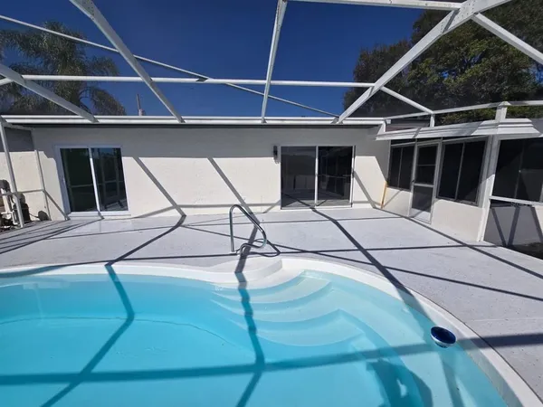 a roof deck with table and chairs