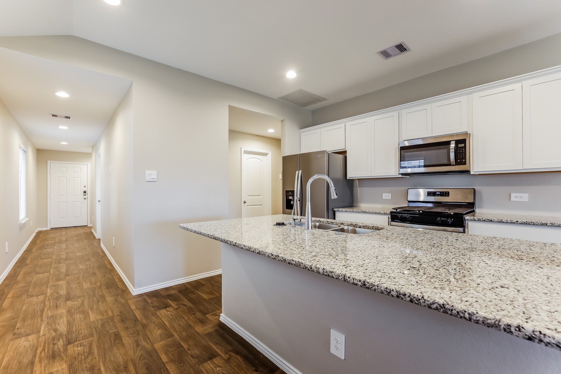 10011 Lavender Lane Magnolia, TX 77355 - Photo 6 of 15 a kitchen with sink a refrigerator and microwave