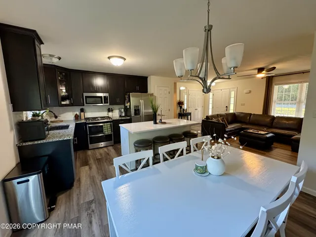 a large kitchen with a table and chairs