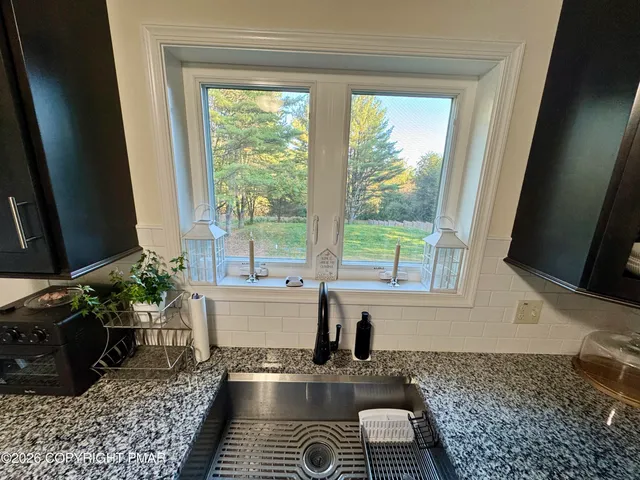 a kitchen with a window a sink and a counter