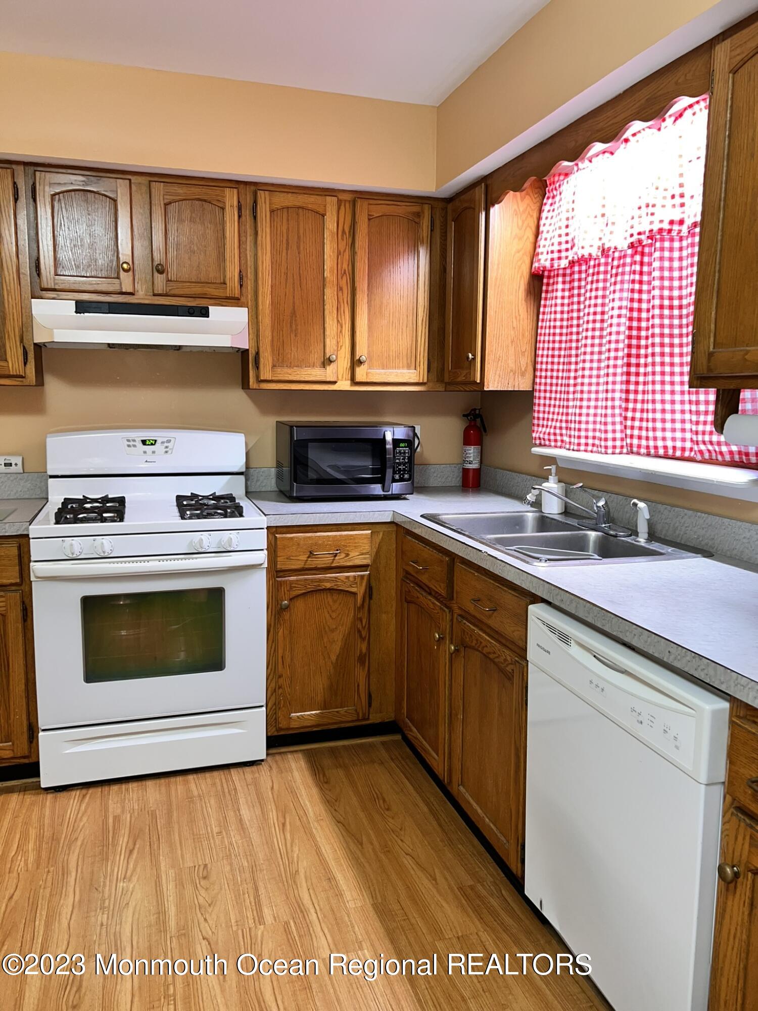 515 Eastern Boulevard Bayville, NJ 08721 - Photo 11 of 38 a kitchen with a stove top oven sink and cabinets