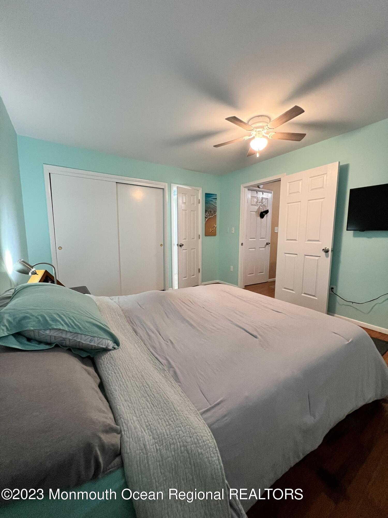 515 Eastern Boulevard Bayville, NJ 08721 - Photo 14 of 38 a bedroom with a bed and a large mirror