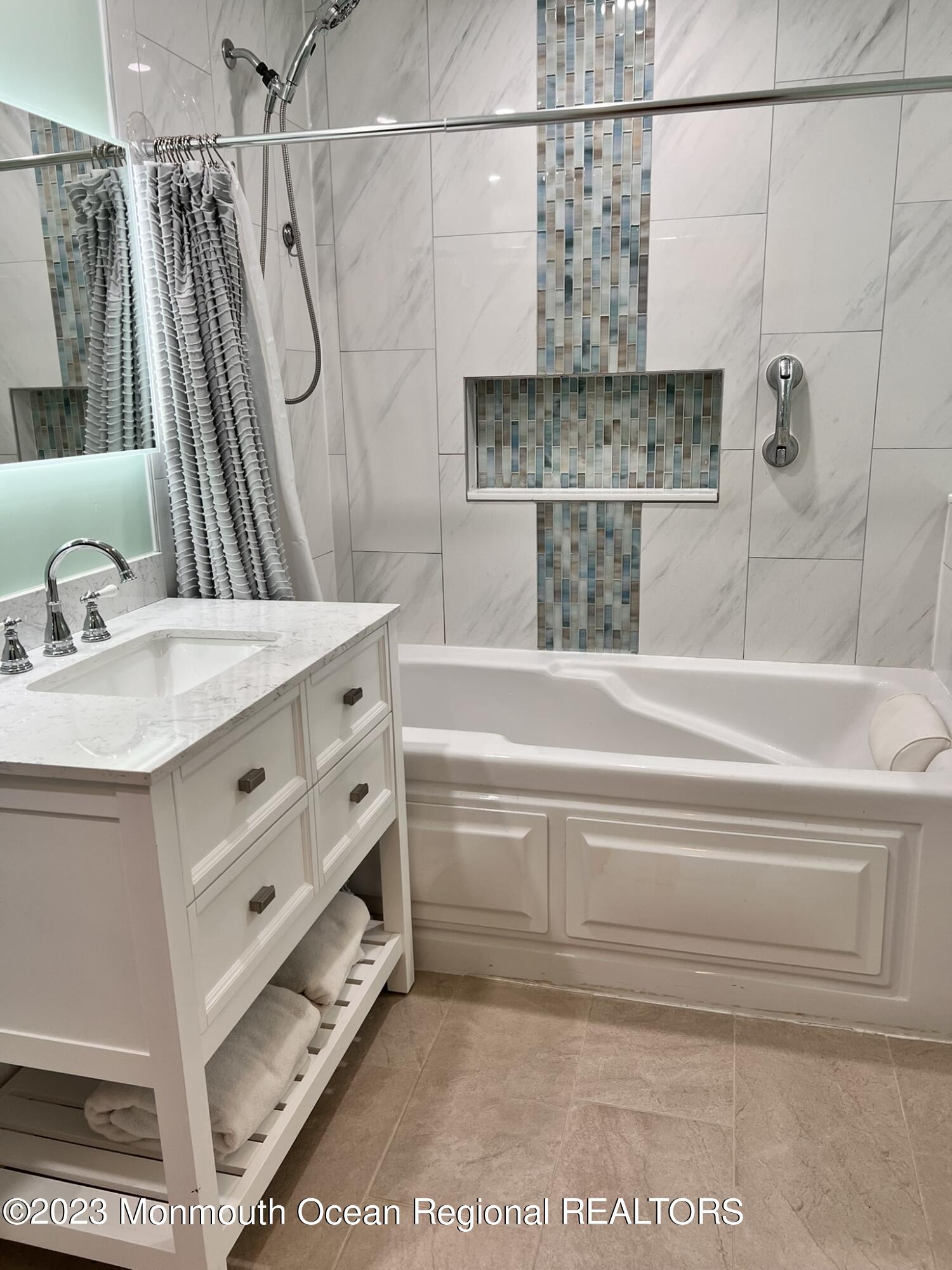 515 Eastern Boulevard Bayville, NJ 08721 - Photo 17 of 38 a bathroom with a bathtub and a shower