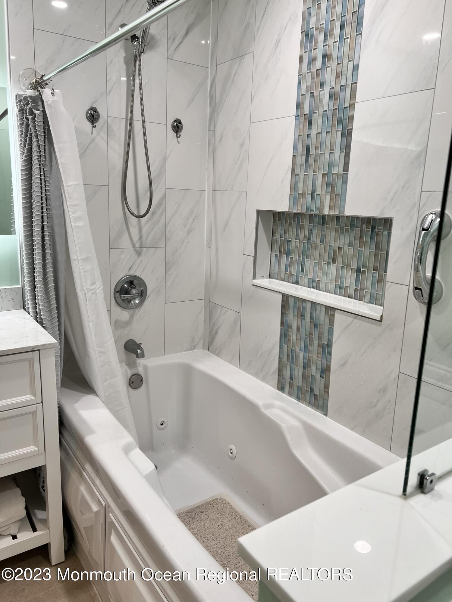 515 Eastern Boulevard Bayville, NJ 08721 - Photo 18 of 38 a bathroom with a tub a sink and a shower