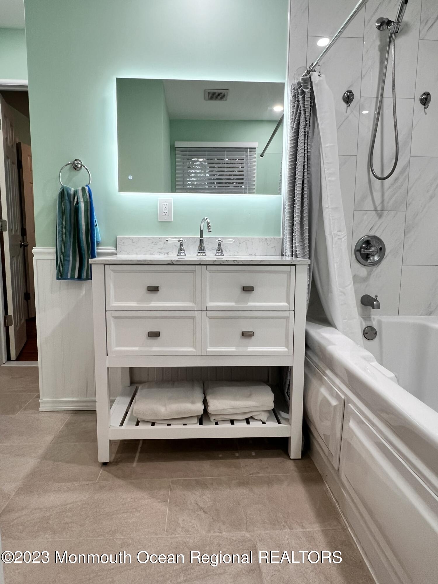 515 Eastern Boulevard Bayville, NJ 08721 - Photo 19 of 38 a bathroom with a tub sink and mirror