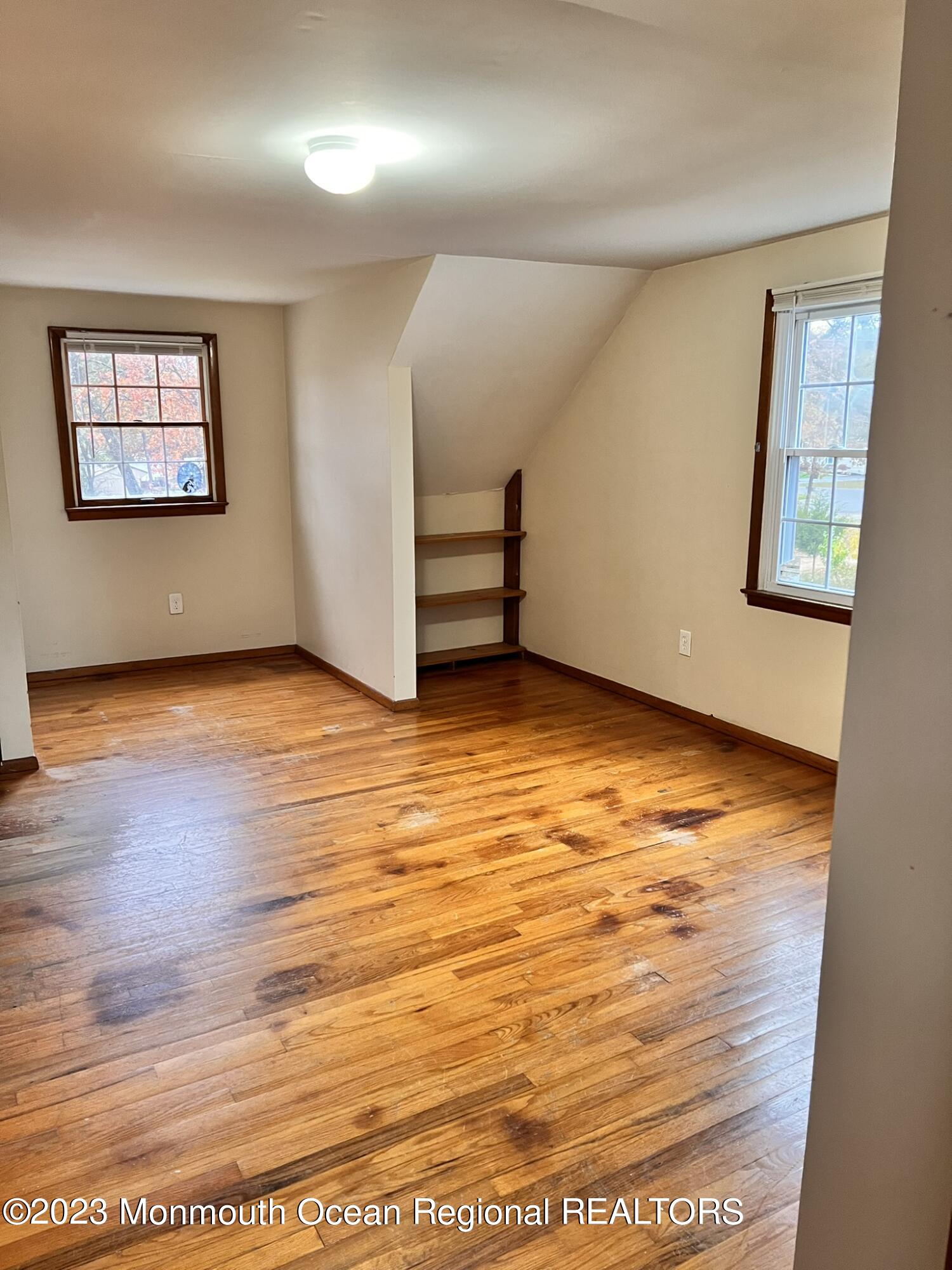 515 Eastern Boulevard Bayville, NJ 08721 - Photo 21 of 38 an empty room with wooden floor and windows