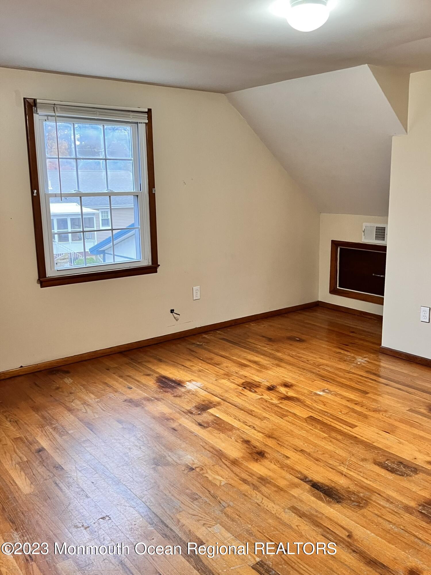 515 Eastern Boulevard Bayville, NJ 08721 - Photo 22 of 38 an empty room with wooden floor and windows