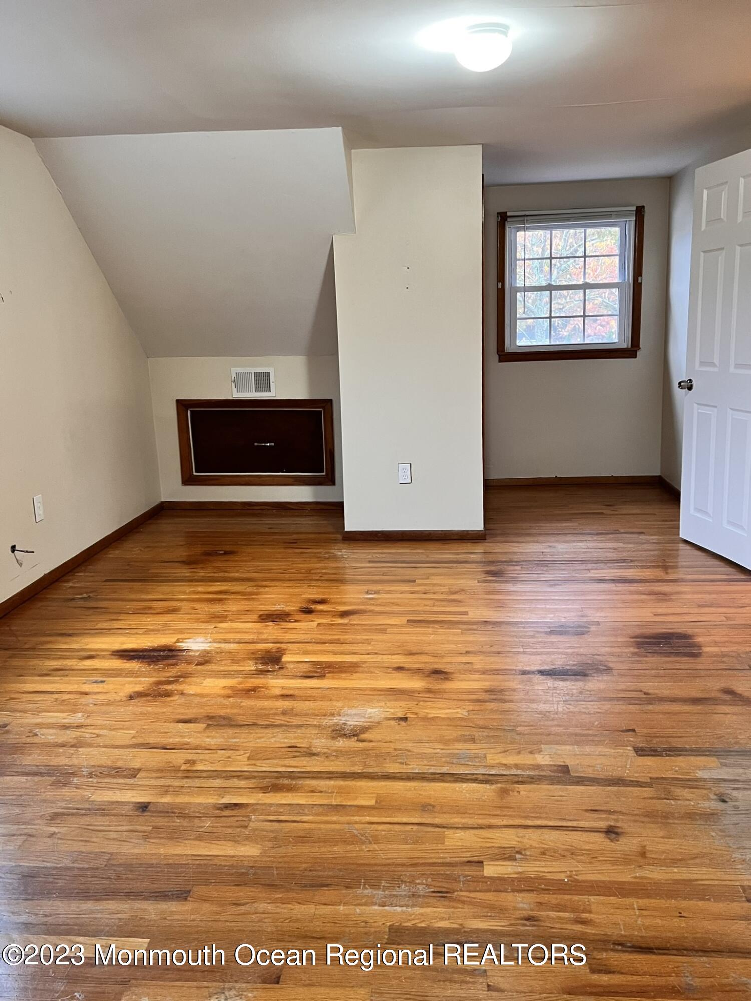 515 Eastern Boulevard Bayville, NJ 08721 - Photo 23 of 38 an empty room with wooden floor and windows