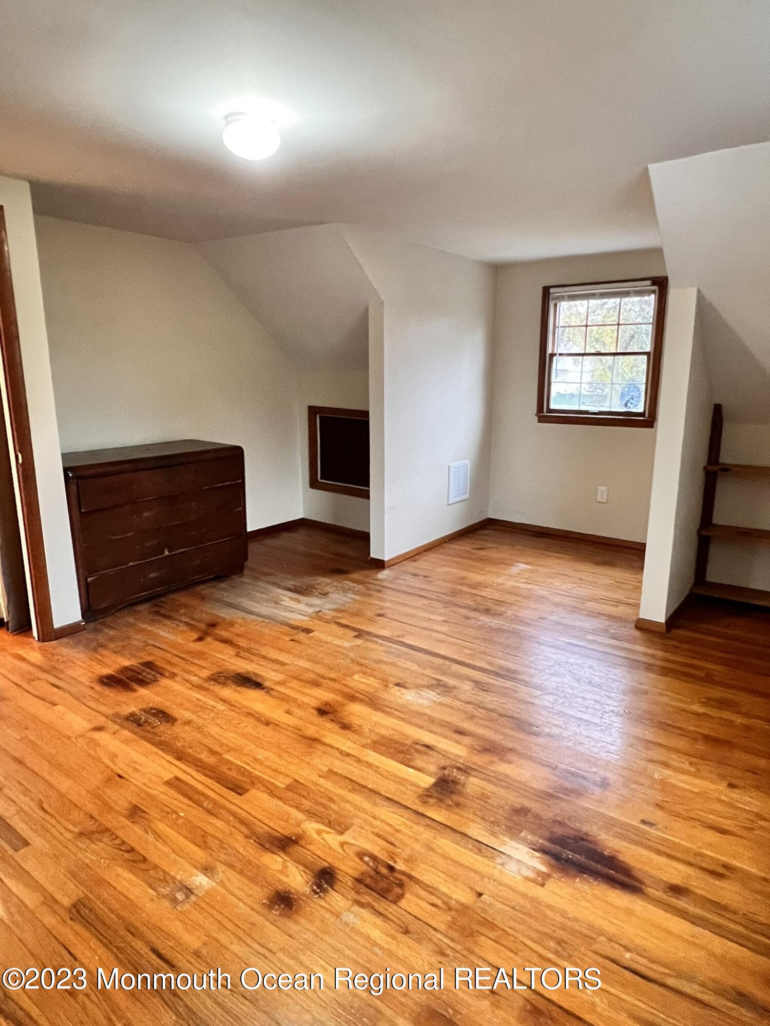 515 Eastern Boulevard Bayville, NJ 08721 - Photo 24 of 38 an empty room with wooden floor and window
