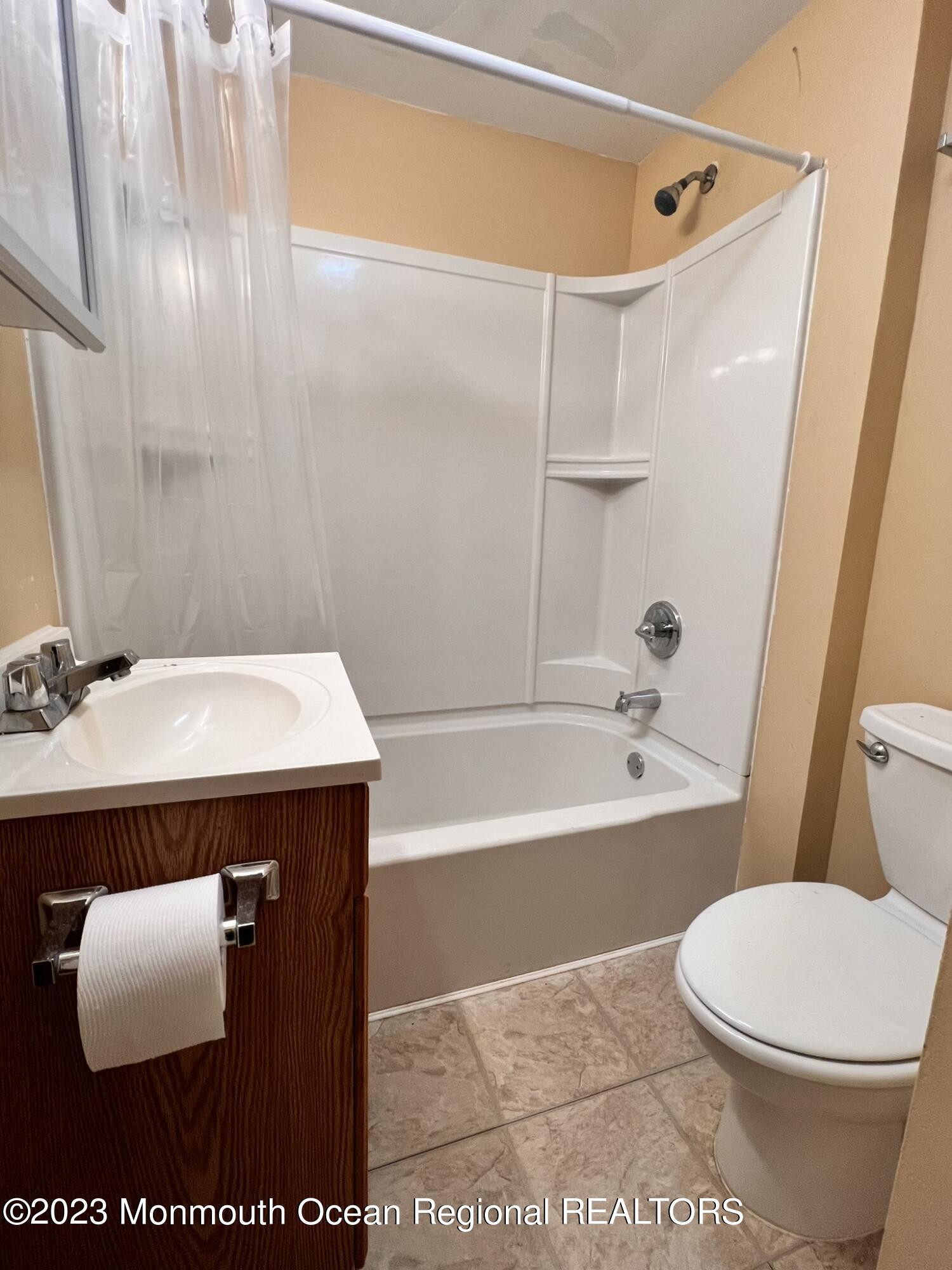 515 Eastern Boulevard Bayville, NJ 08721 - Photo 25 of 38 a bathroom with a sink a toilet and a bathtub