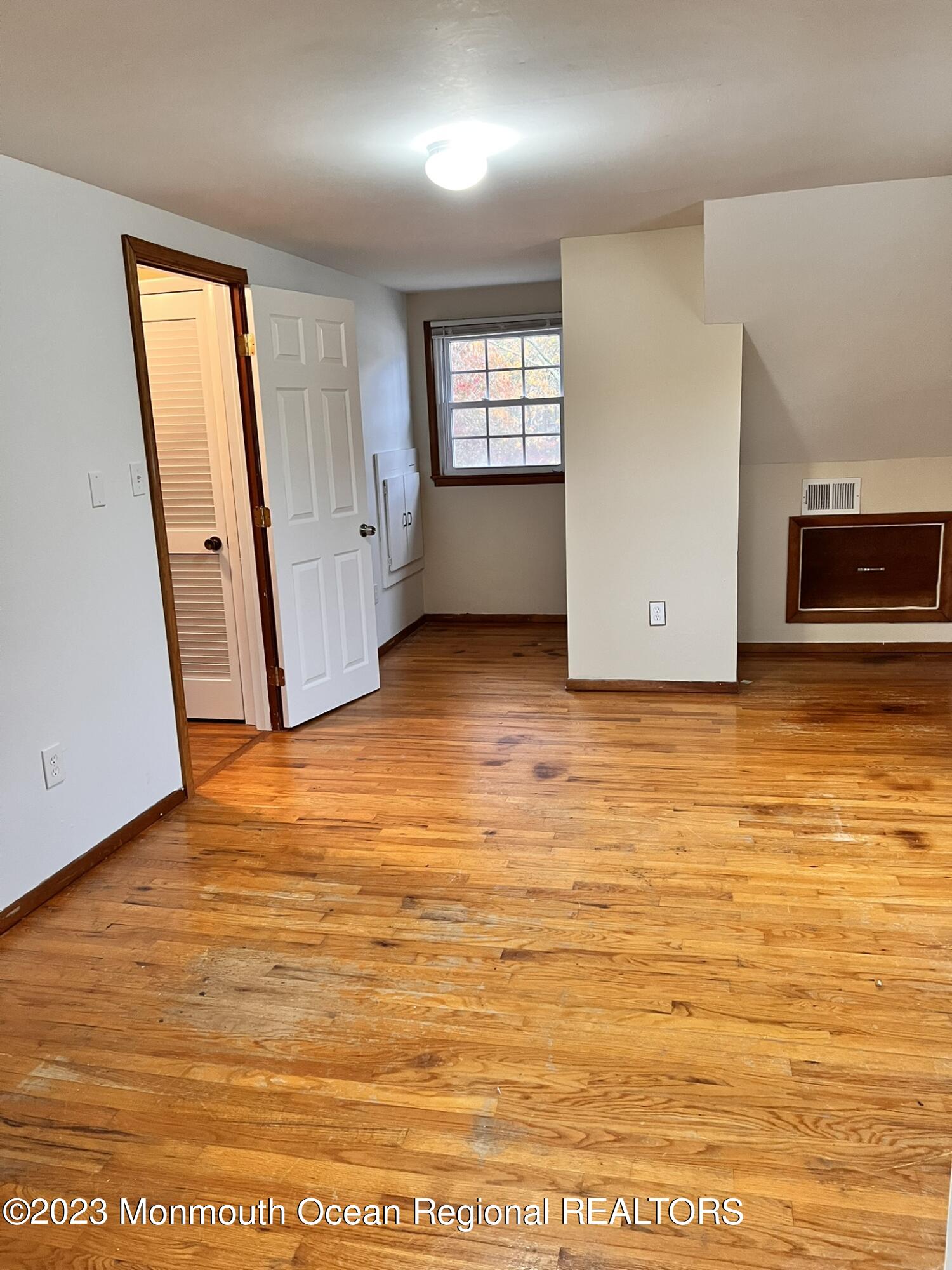 515 Eastern Boulevard Bayville, NJ 08721 - Photo 27 of 38 an empty room with wooden floor and windows