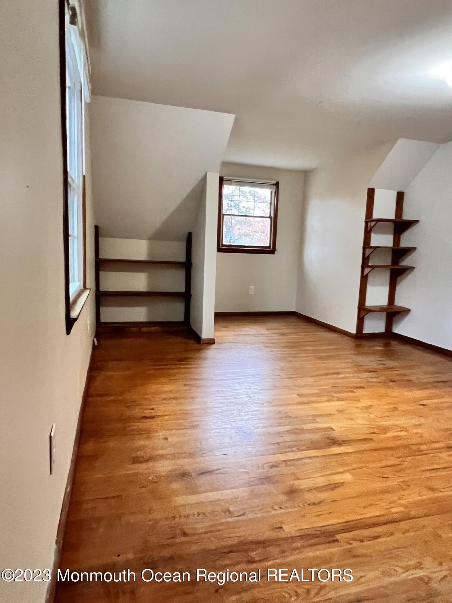 515 Eastern Boulevard Bayville, NJ 08721 - Photo 28 of 38 a view of empty room with wooden floor and fan