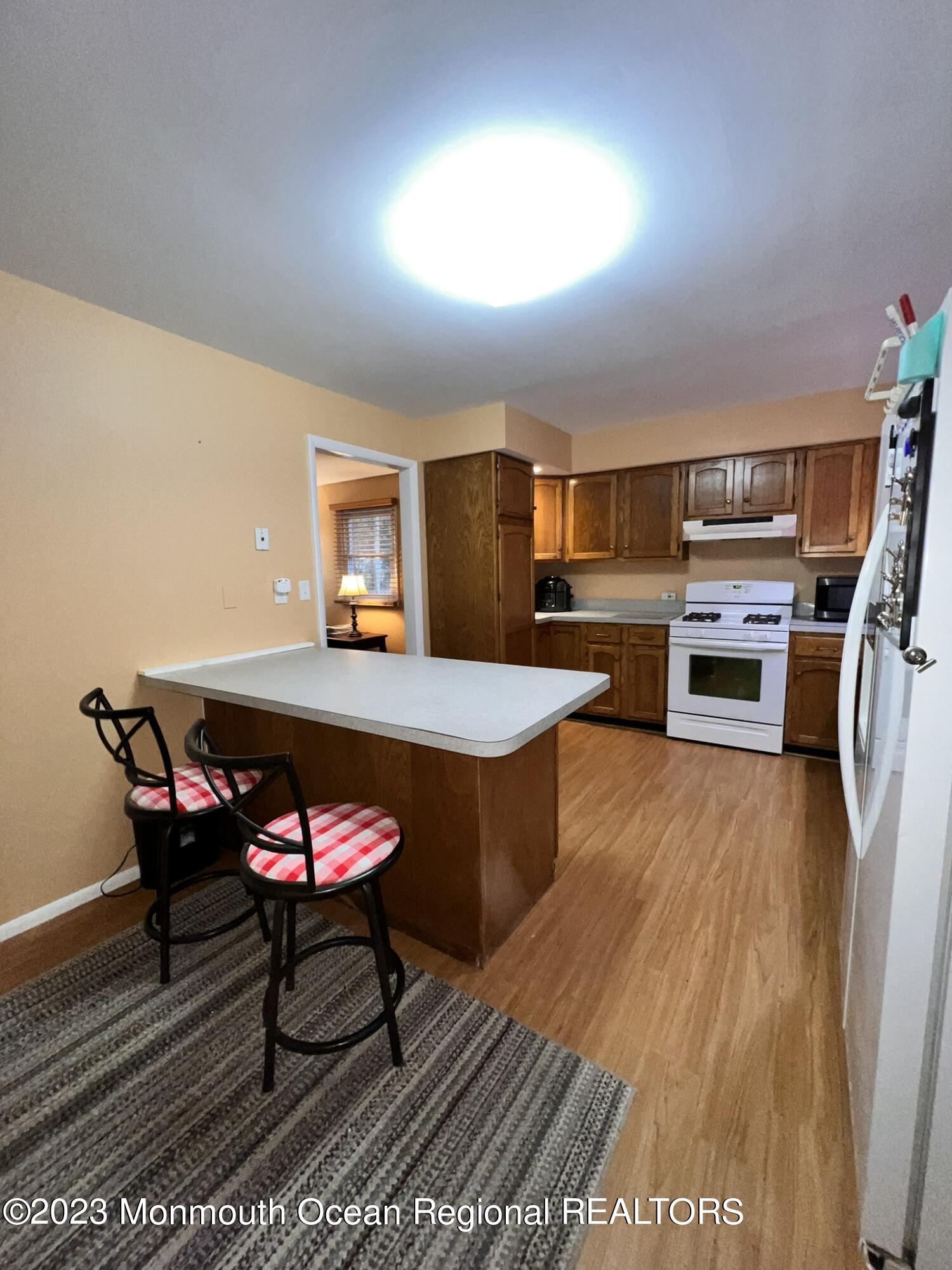 515 Eastern Boulevard Bayville, NJ 08721 - Photo 9 of 38 a open kitchen with a table and chairs