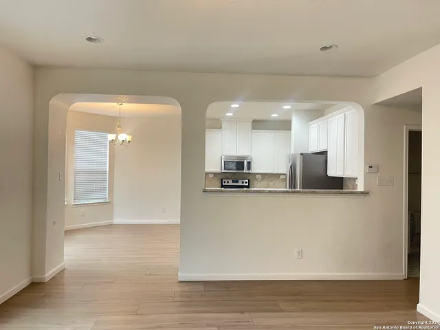 a view of kitchen with kitchen island a sink appliances and a counter top space