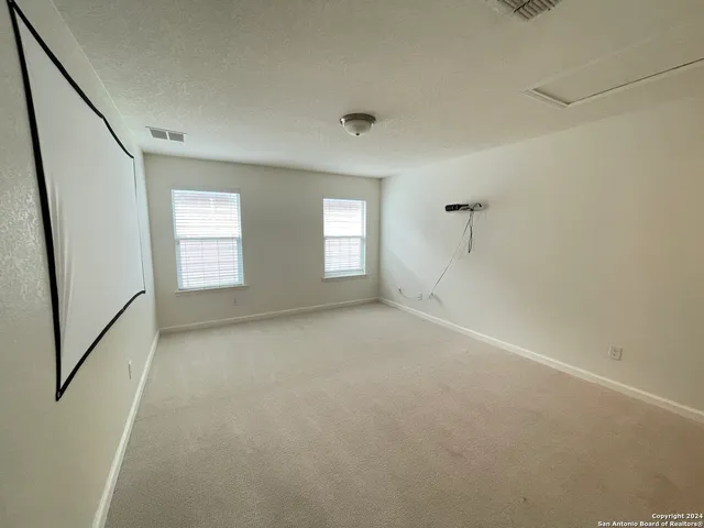 a view of an empty room with windows