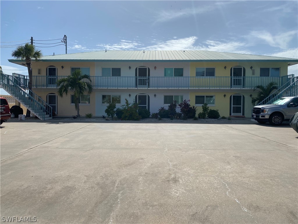 3211 Stringfellow Road, Unit 1D St. James City, FL 33956 - Photo 1 of 22 a front view of a house with a yard
