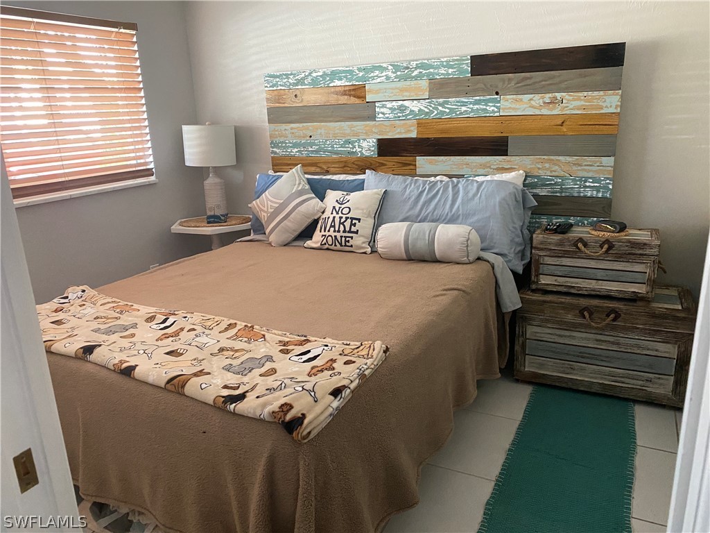 3211 Stringfellow Road, Unit 1D St. James City, FL 33956 - Photo 11 of 22 a bedroom with a bed and window