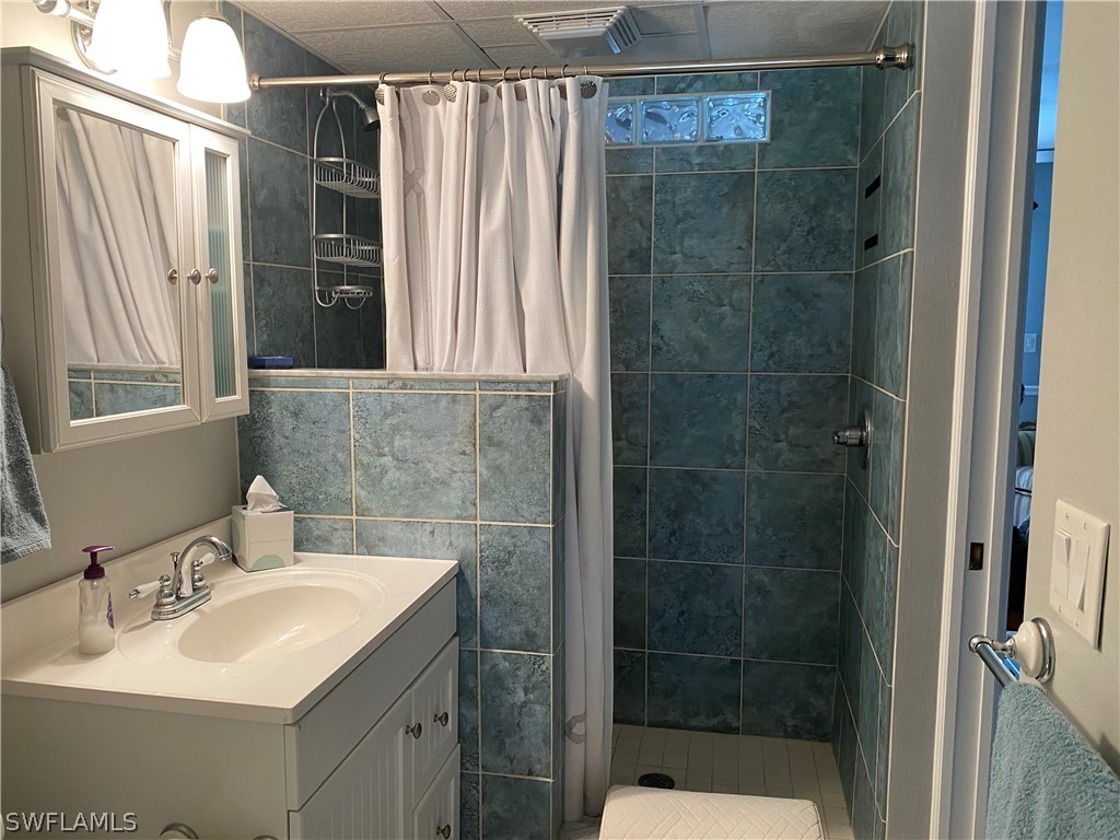 3211 Stringfellow Road, Unit 1D St. James City, FL 33956 - Photo 13 of 22 a bathroom with a sink toilet and shower