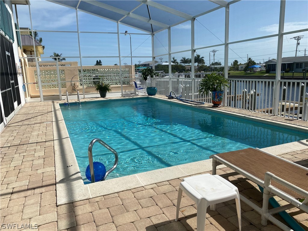 3211 Stringfellow Road, Unit 1D St. James City, FL 33956 - Photo 16 of 22 a view of a patio with a table chairs and potted plants