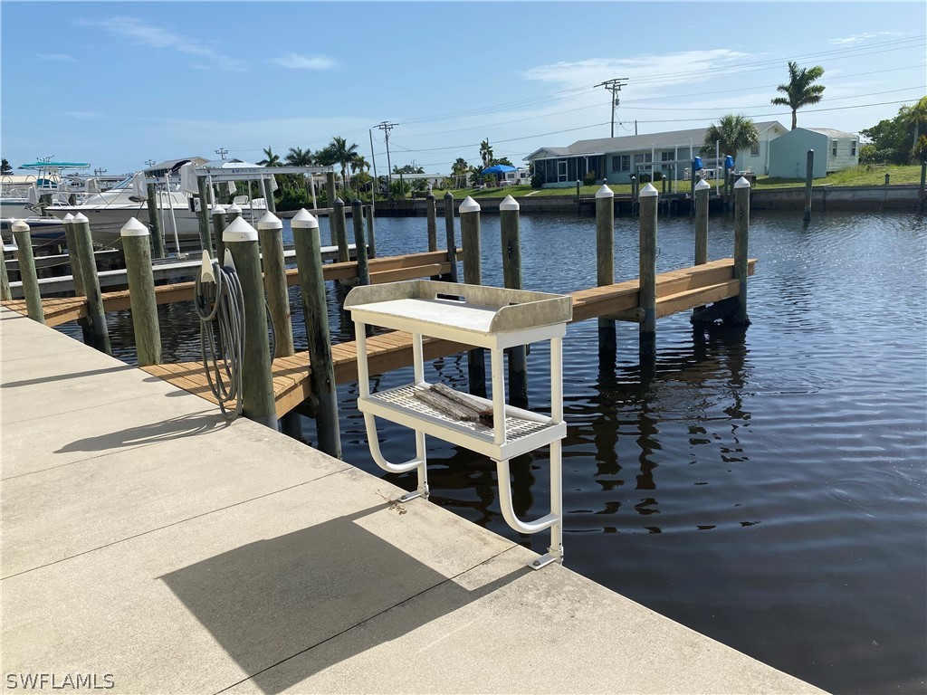 3211 Stringfellow Road, Unit 1D St. James City, FL 33956 - Photo 20 of 22 a terrace with a table and chairs