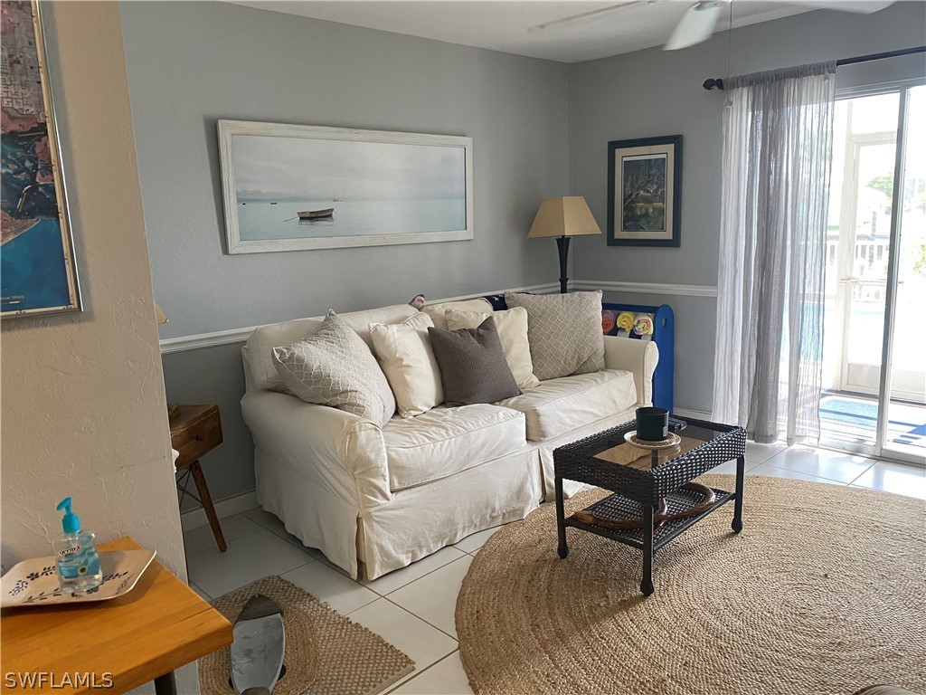 3211 Stringfellow Road, Unit 1D St. James City, FL 33956 - Photo 6 of 22 a living room with furniture and a wooden floor