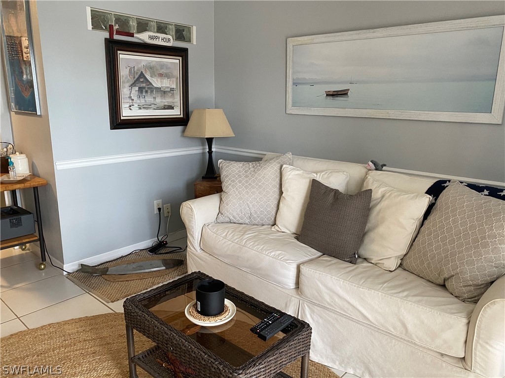 3211 Stringfellow Road, Unit 1D St. James City, FL 33956 - Photo 7 of 22 a living room with a couch and a table