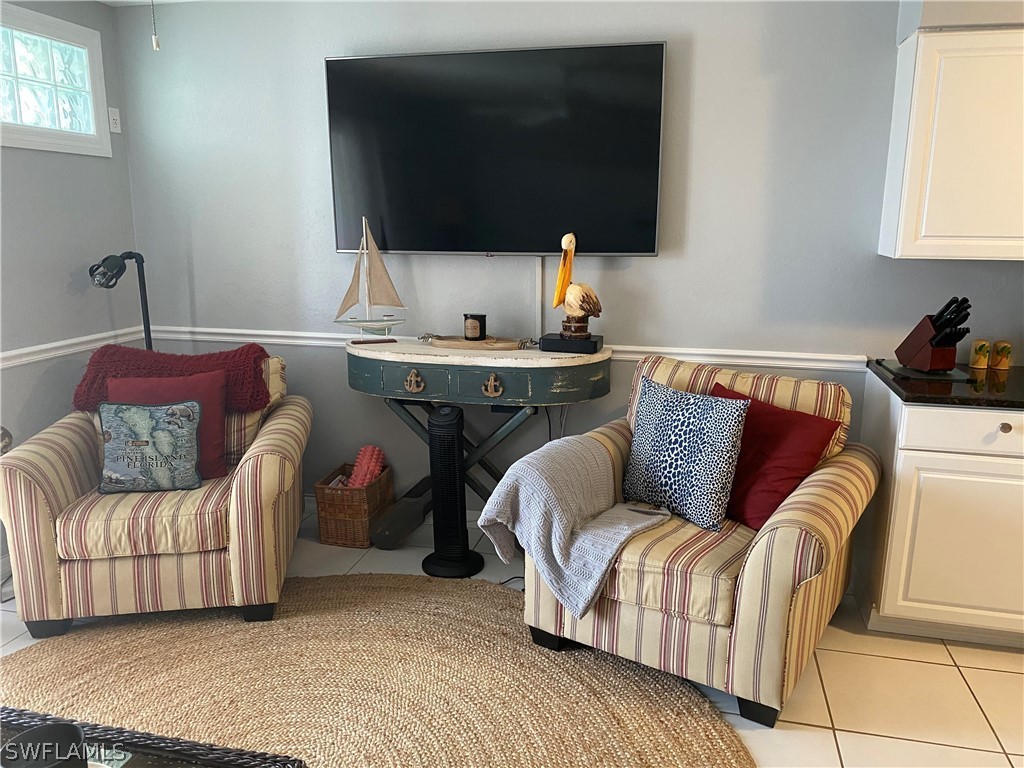3211 Stringfellow Road, Unit 1D St. James City, FL 33956 - Photo 8 of 22 a living room with furniture and a flat screen tv