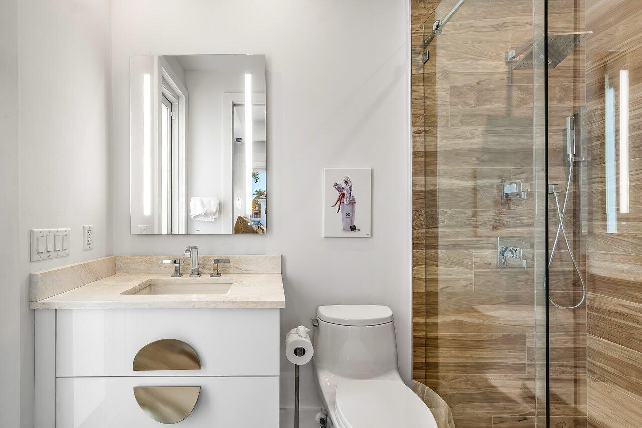 3506 Northwest Clubside Circle Boca Raton, FL 33496 - Photo 19 of 46 a bathroom with a sink a toilet and shower