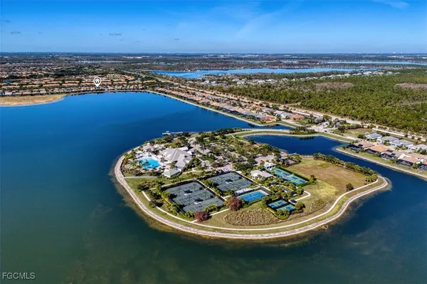 an aerial view of a house with a yard and lake view