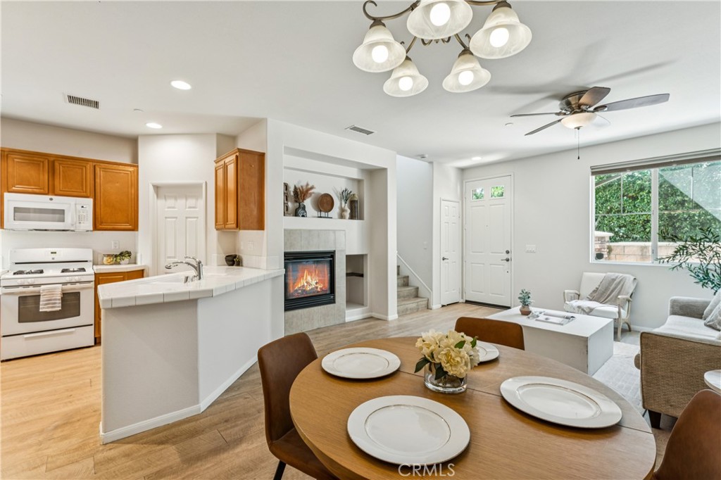 8048 Tulsa Place, Unit 105 Rancho Cucamonga, CA 91730 - Photo 11 of 45 a kitchen with stainless steel appliances a dining table and chairs