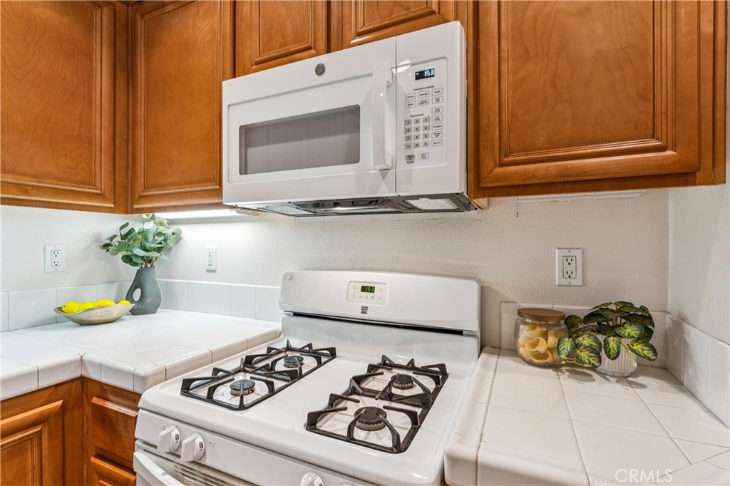 8048 Tulsa Place, Unit 105 Rancho Cucamonga, CA 91730 - Photo 13 of 45 a kitchen with a stove and a microwave