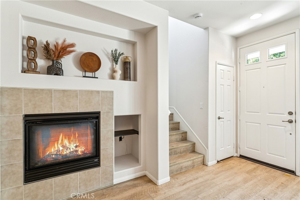 8048 Tulsa Place, Unit 105 Rancho Cucamonga, CA 91730 - Photo 16 of 45 a living room with a fireplace and a flat screen tv