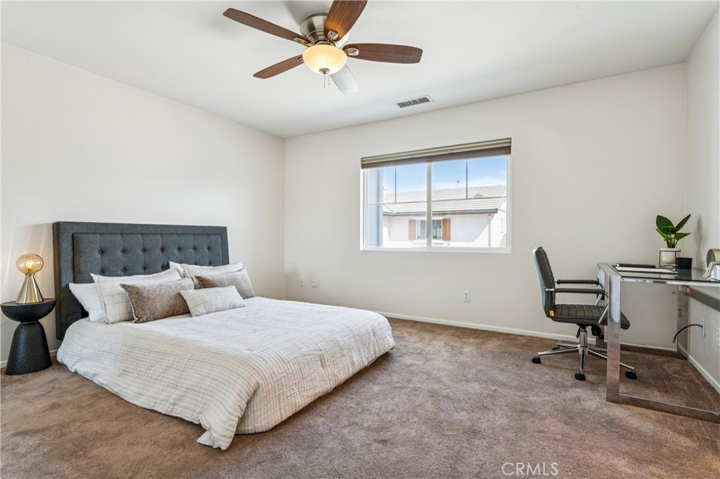 8048 Tulsa Place, Unit 105 Rancho Cucamonga, CA 91730 - Photo 25 of 45 a bedroom with a bed a desk and chair