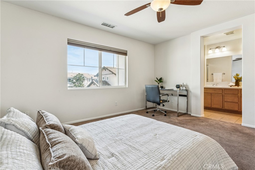 8048 Tulsa Place, Unit 105 Rancho Cucamonga, CA 91730 - Photo 26 of 45 a bedroom with a bed and a chandelier